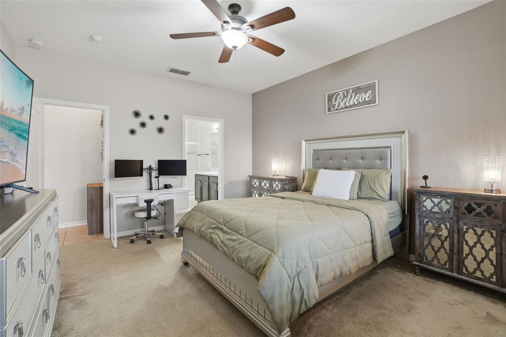 3933 Wind Dancer Circle St. Cloud, FL 34772 - Photo 17 of 35 a bedroom with a bed couch and a window