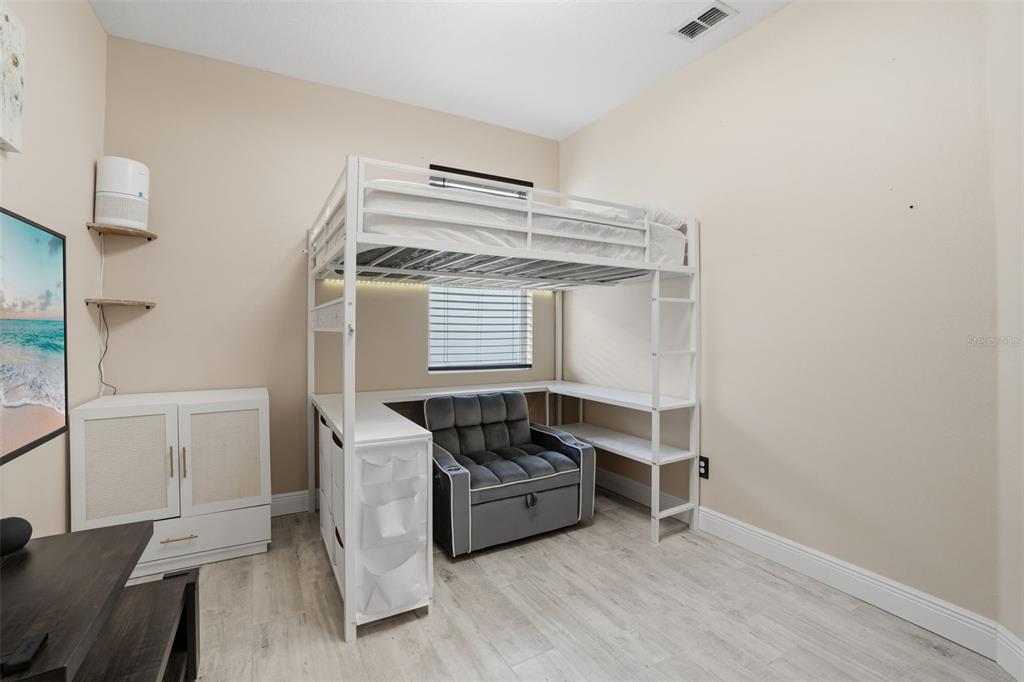 3933 Wind Dancer Circle St. Cloud, FL 34772 - Photo 26 of 35 a bedroom with a bed and a window