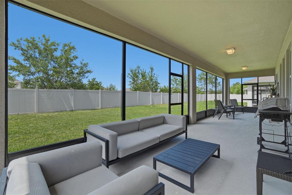 3933 Wind Dancer Circle St. Cloud, FL 34772 - Photo 30 of 35 a outdoor space with patio couch and a garden