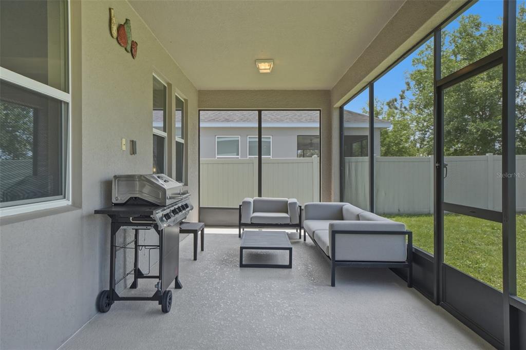 3933 Wind Dancer Circle St. Cloud, FL 34772 - Photo 31 of 35 a living room with furniture and a floor to ceiling window