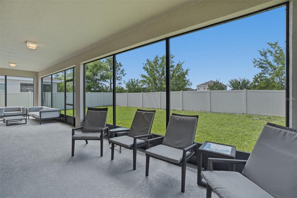 3933 Wind Dancer Circle St. Cloud, FL 34772 - Photo 32 of 35 a outdoor living space with furniture and a garden view