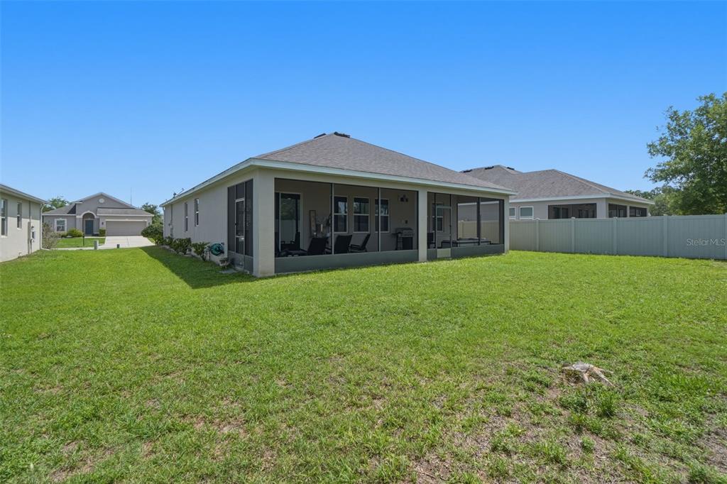 3933 Wind Dancer Circle St. Cloud, FL 34772 - Photo 33 of 35 a view of a house with a yard