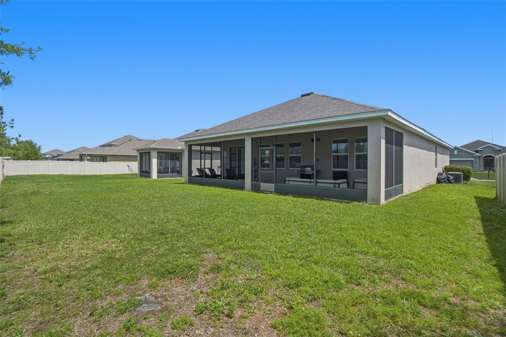 3933 Wind Dancer Circle St. Cloud, FL 34772 - Photo 34 of 35 a view of a house with a yard