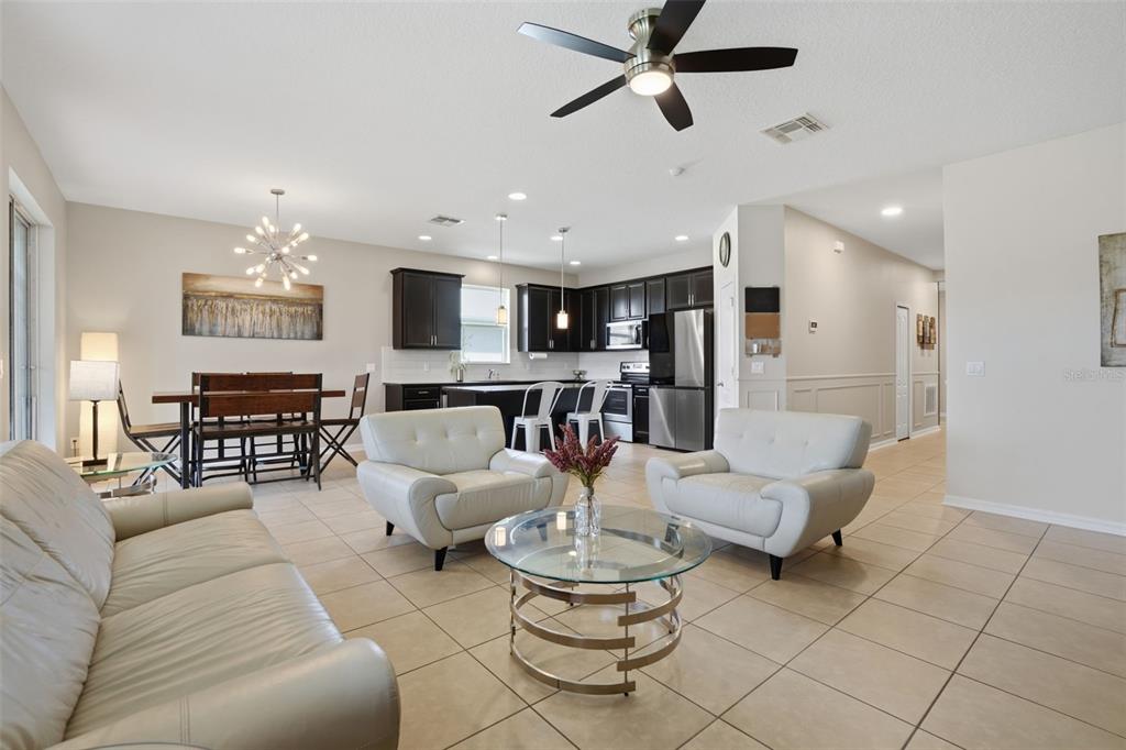 3933 Wind Dancer Circle St. Cloud, FL 34772 - Photo 8 of 35 a living room with furniture and a chandelier