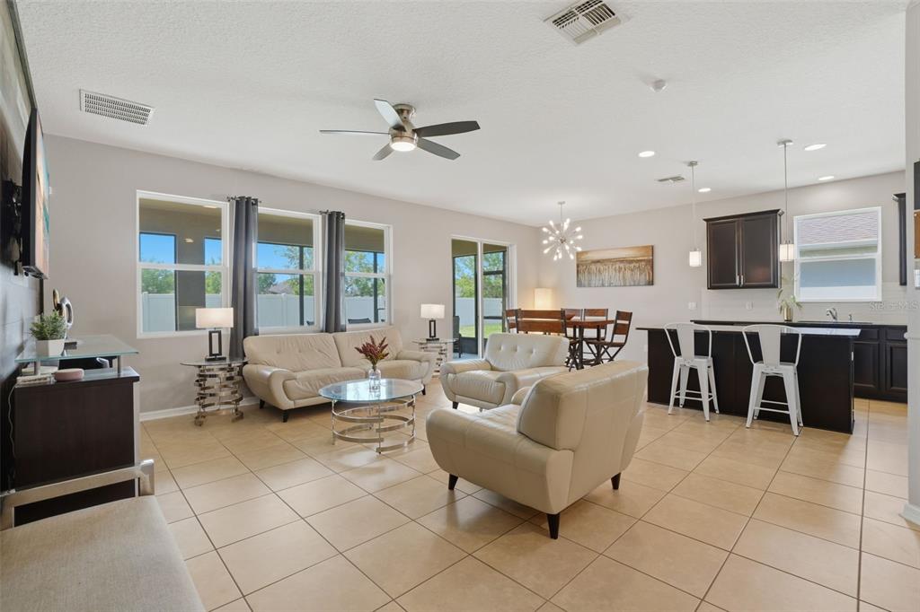 3933 Wind Dancer Circle St. Cloud, FL 34772 - Photo 9 of 35 a living room with furniture and a view of kitchen