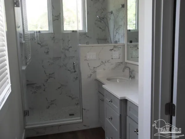 a bathroom with a shower and a sink