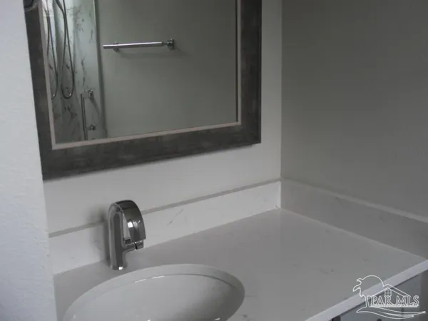 a bathroom with a sink and mirror