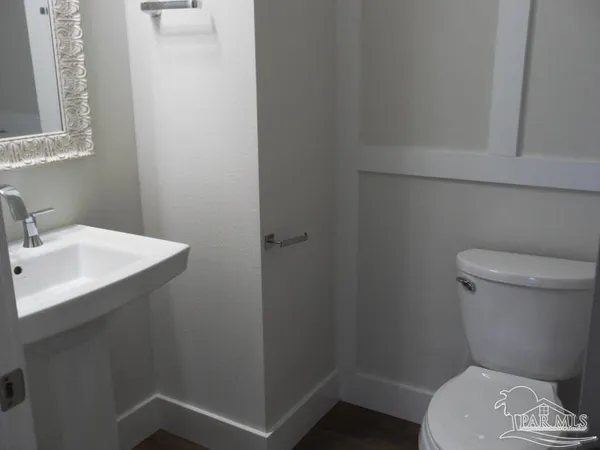 a white toilet sitting next to a bathroom sink