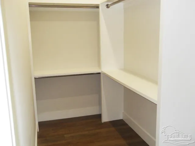 a view of walk in closet with empty racks