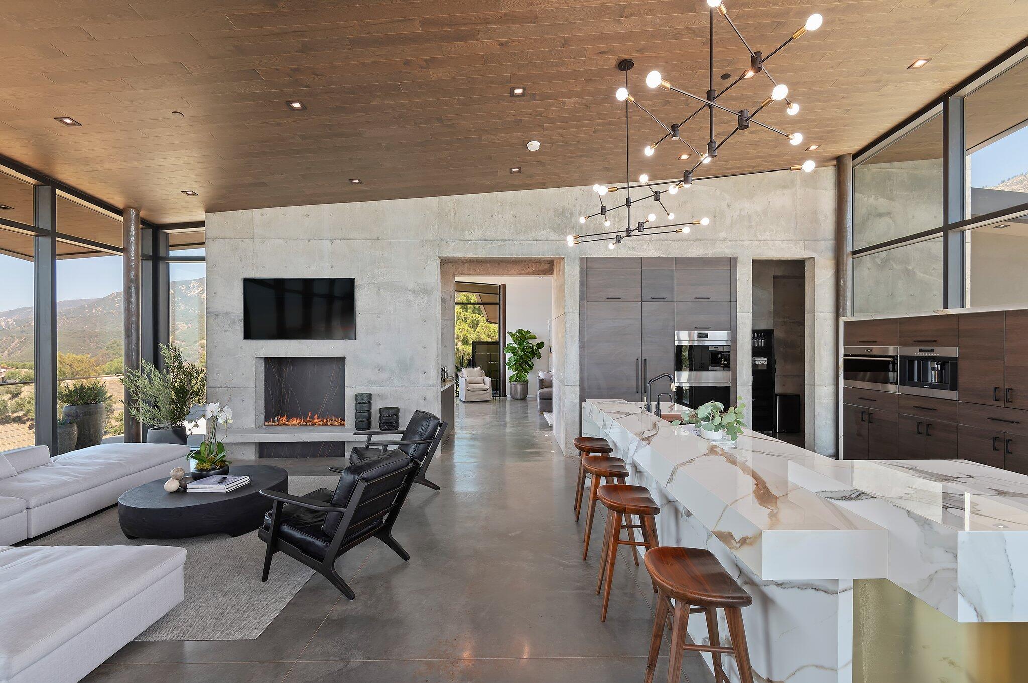 2805 Spyglass Ridge Road Santa Barbara, CA 93105 - Photo 16 of 67 a living room with furniture a chandelier and a dining table