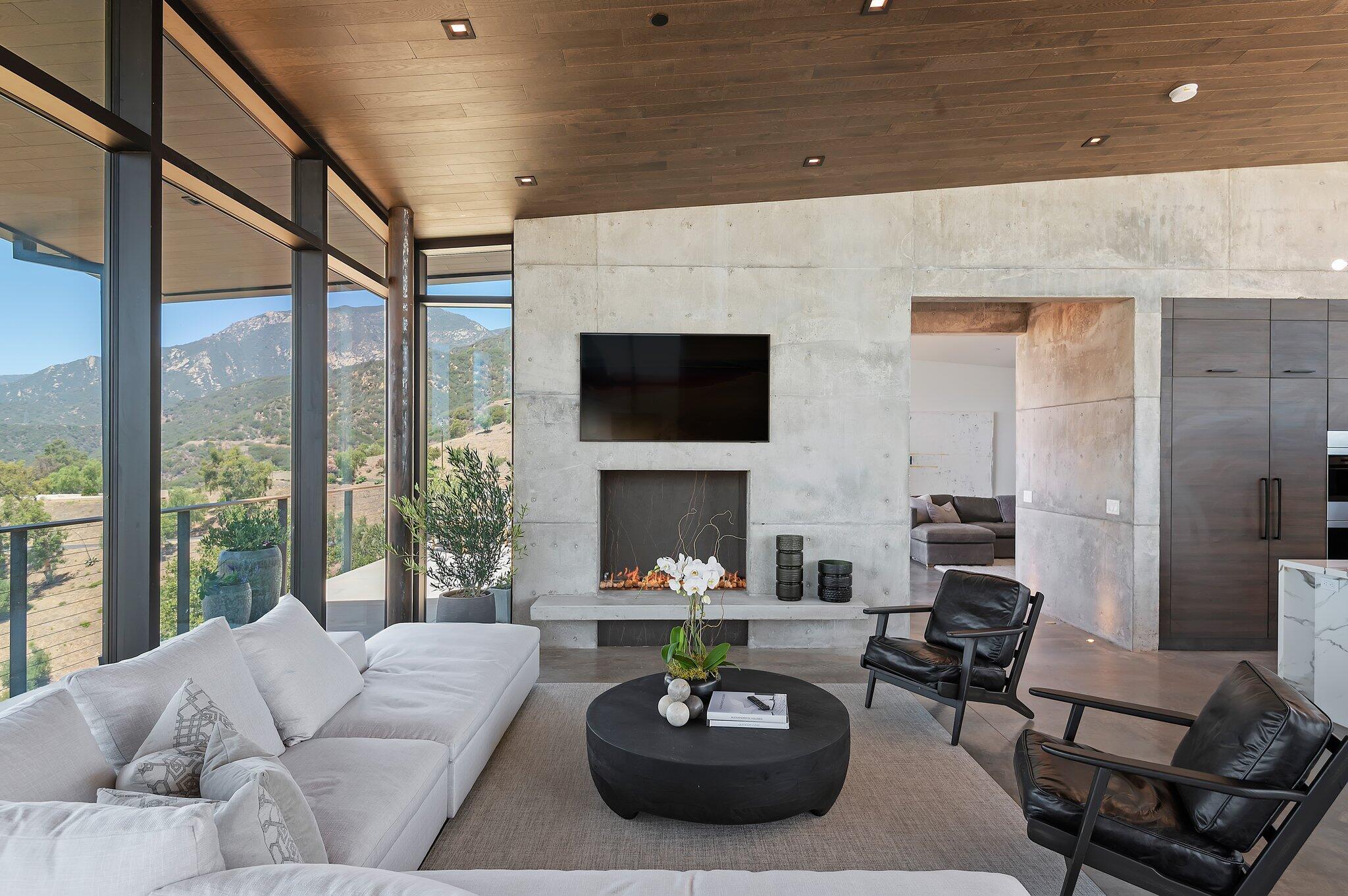 2805 Spyglass Ridge Road Santa Barbara, CA 93105 - Photo 17 of 67 a living room with furniture a fireplace and a large window