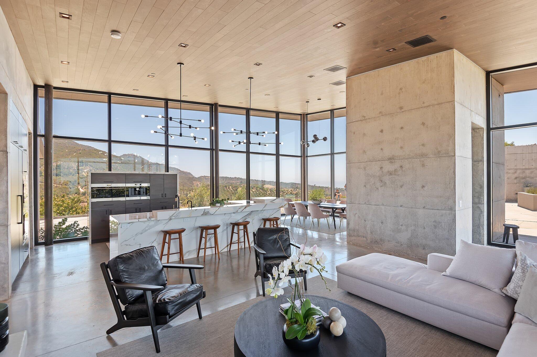 2805 Spyglass Ridge Road Santa Barbara, CA 93105 - Photo 19 of 67 a living room with furniture a chandelier and a floor to ceiling window