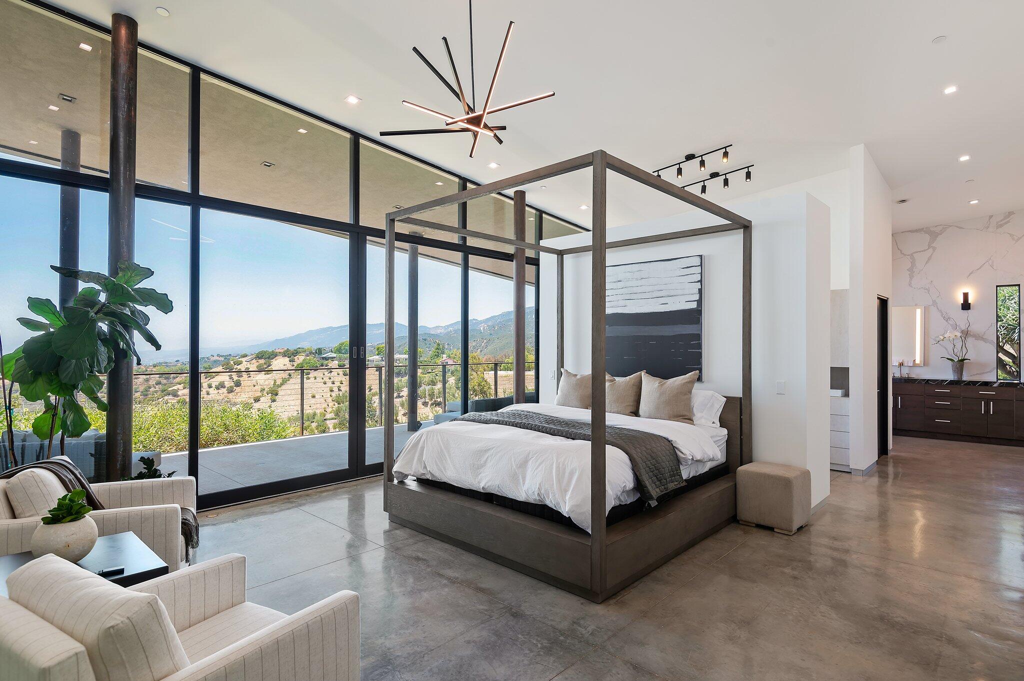 2805 Spyglass Ridge Road Santa Barbara, CA 93105 - Photo 35 of 67 a spacious bedroom with a bed a couch and a large window