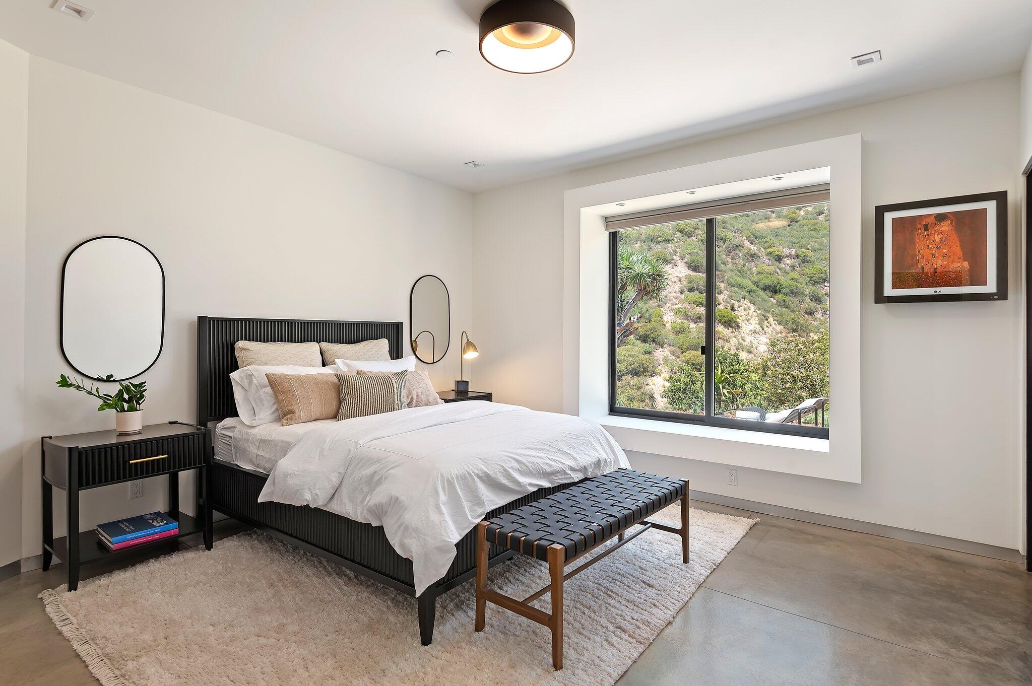 2805 Spyglass Ridge Road Santa Barbara, CA 93105 - Photo 44 of 67 a bedroom with a bed a mirror and a window