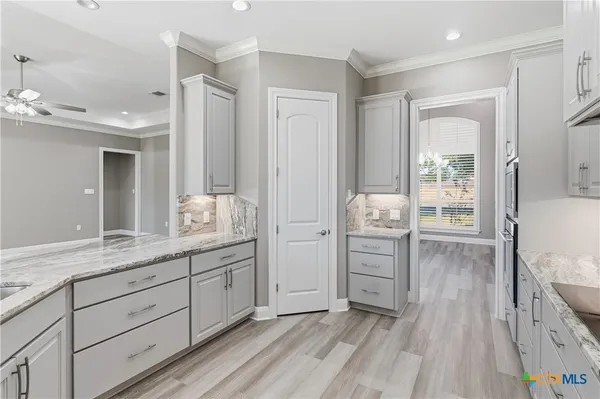 a bathroom with a granite countertop sink mirror and shower