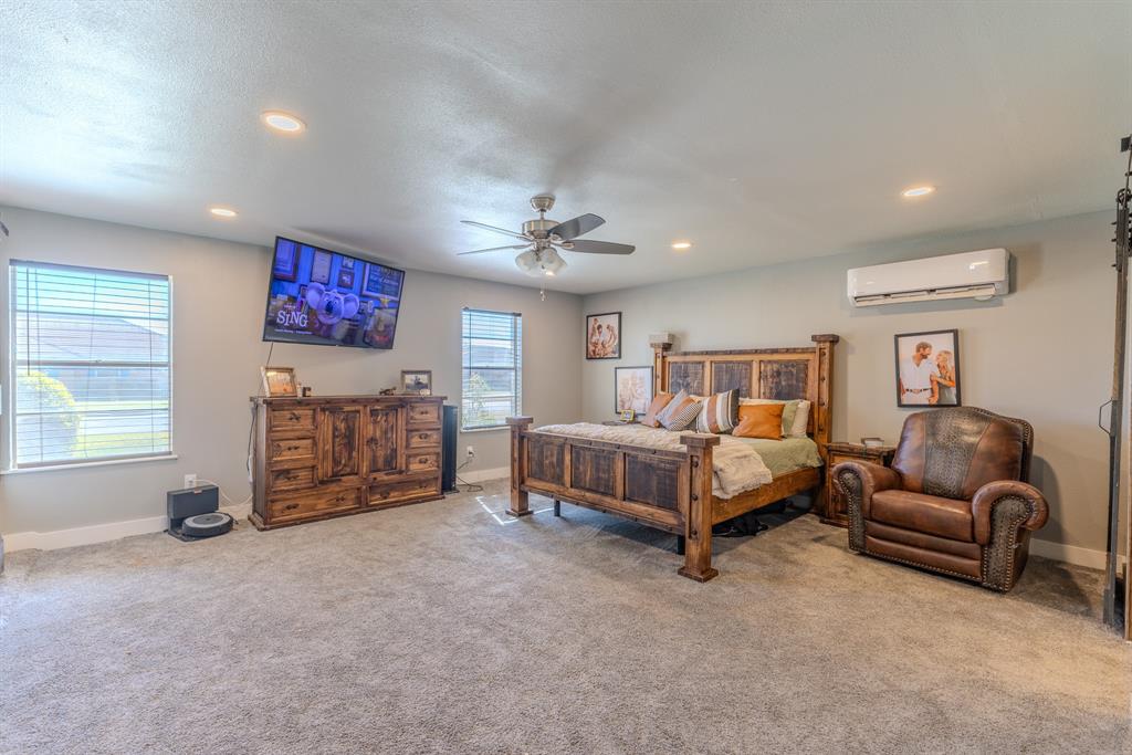1300 Hillcrest Road Coleman, TX 76834 - Photo 12 of 35 a spacious bedroom with a bed and a couch