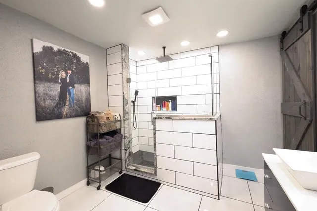 a bathroom with a sink toilet and shower