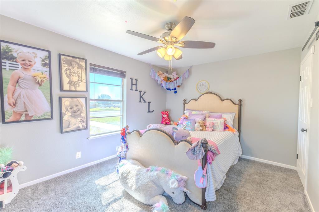 1300 Hillcrest Road Coleman, TX 76834 - Photo 17 of 35 a bedroom with a bed and a chandelier