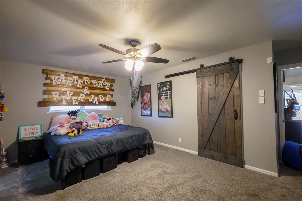 1300 Hillcrest Road Coleman, TX 76834 - Photo 22 of 35 a bedroom with a bed and a chandelier