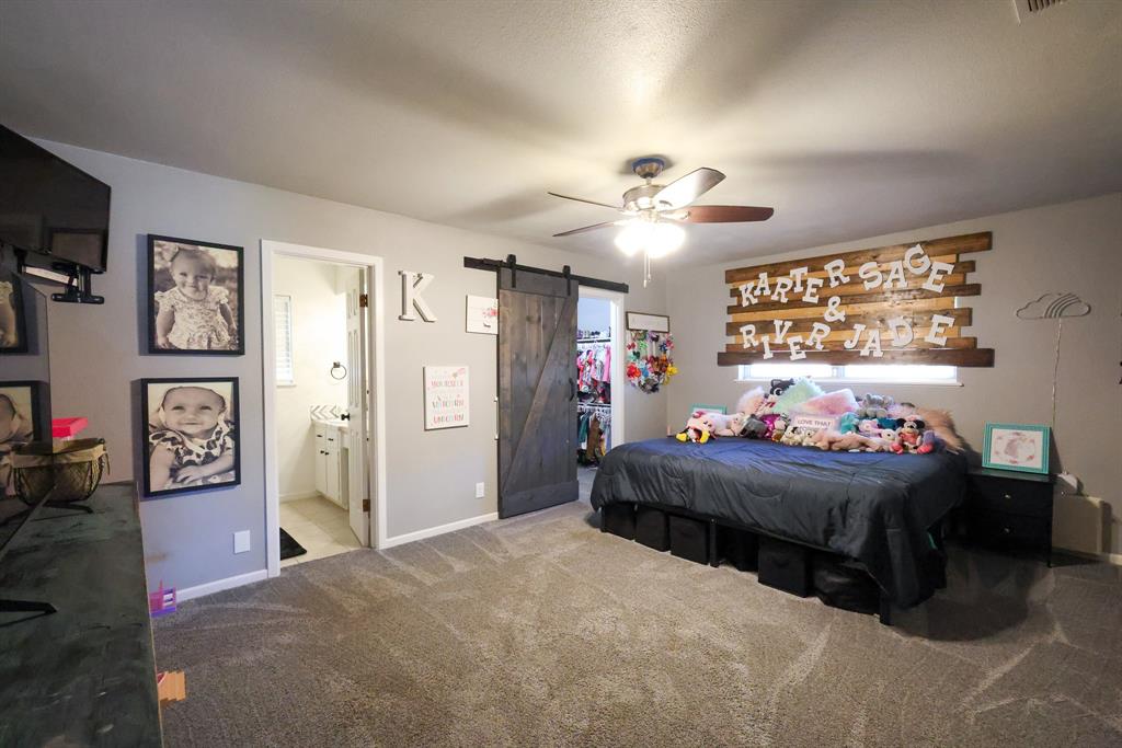 1300 Hillcrest Road Coleman, TX 76834 - Photo 23 of 35 a bedroom with a bed and a chandelier