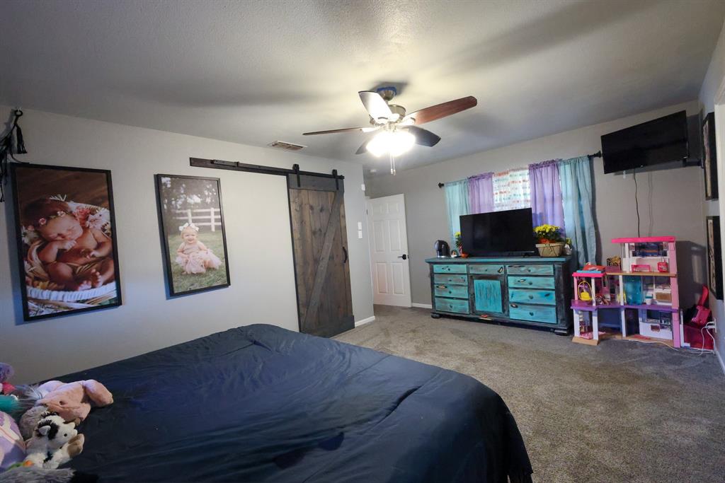 1300 Hillcrest Road Coleman, TX 76834 - Photo 25 of 35 a bedroom with furniture and a flat screen tv