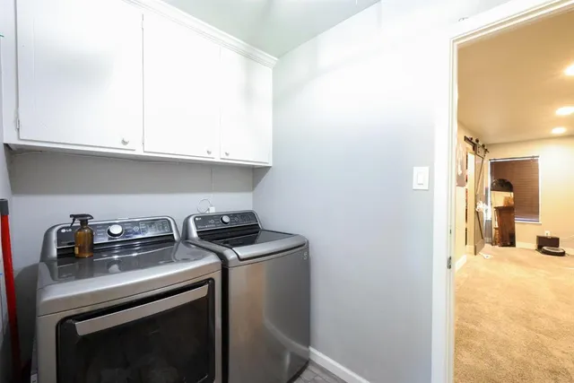 a view of a kitchen with sink and cabinets