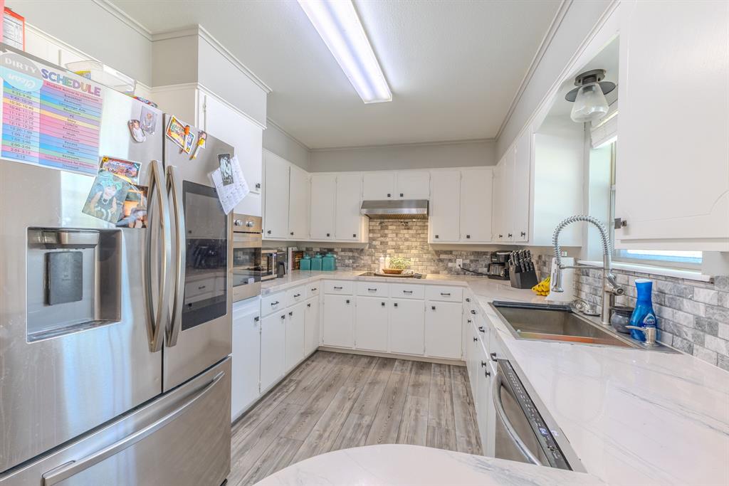 1300 Hillcrest Road Coleman, TX 76834 - Photo 6 of 35 a kitchen with stainless steel appliances a refrigerator sink and cabinets
