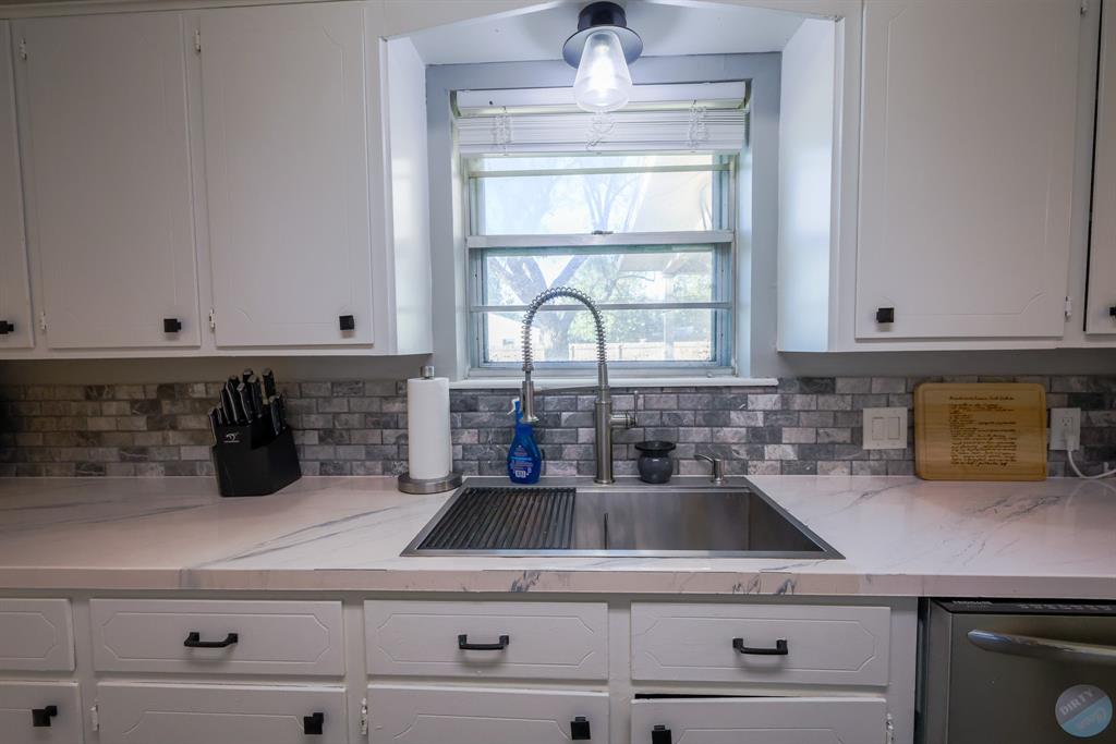 1300 Hillcrest Road Coleman, TX 76834 - Photo 7 of 35 a kitchen with a sink dishwasher a stove and cabinets