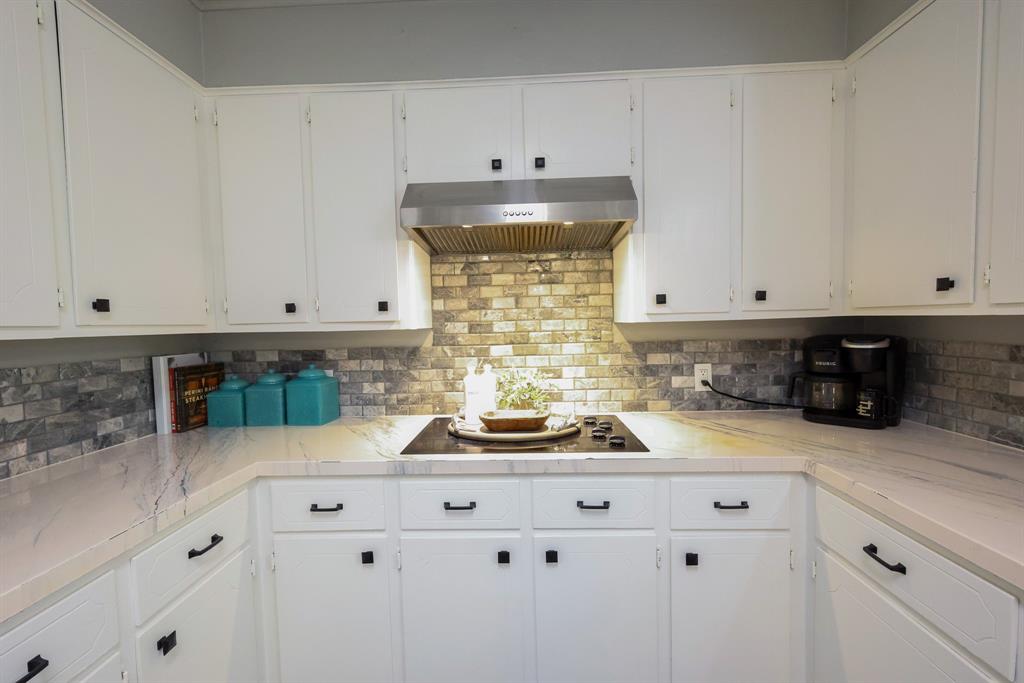 1300 Hillcrest Road Coleman, TX 76834 - Photo 8 of 35 a kitchen with white cabinets and appliances