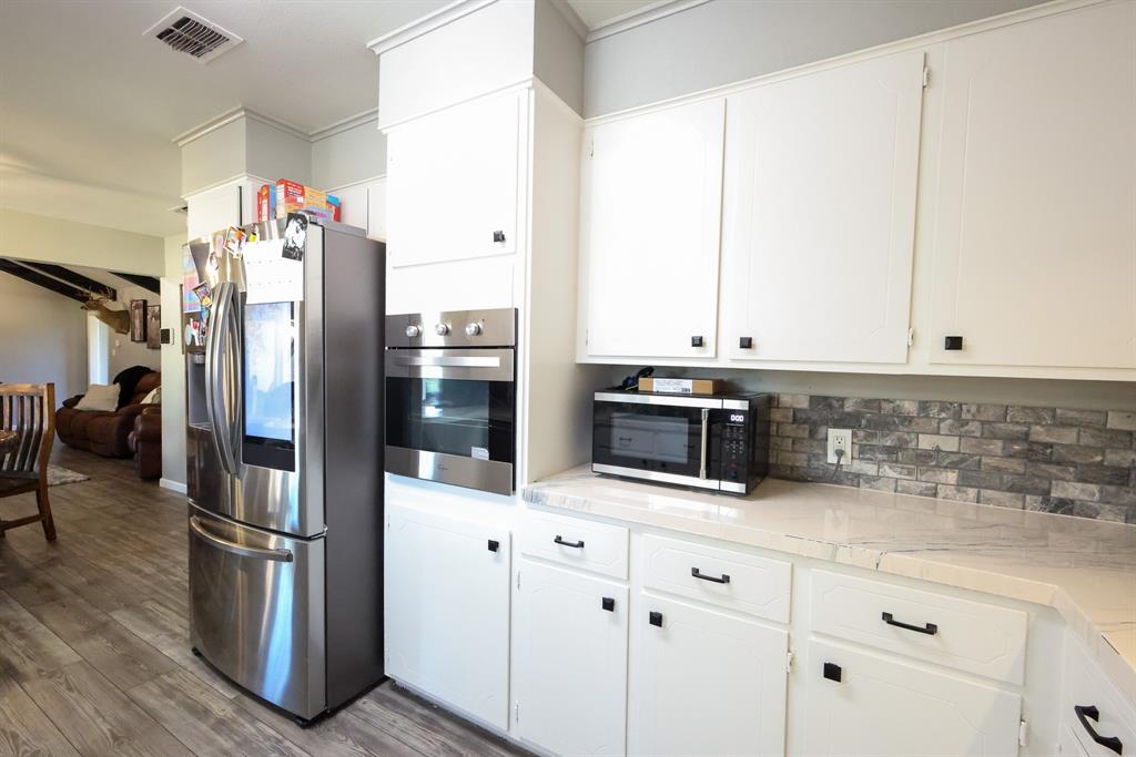 1300 Hillcrest Road Coleman, TX 76834 - Photo 9 of 35 a kitchen with stainless steel appliances a refrigerator sink and microwave