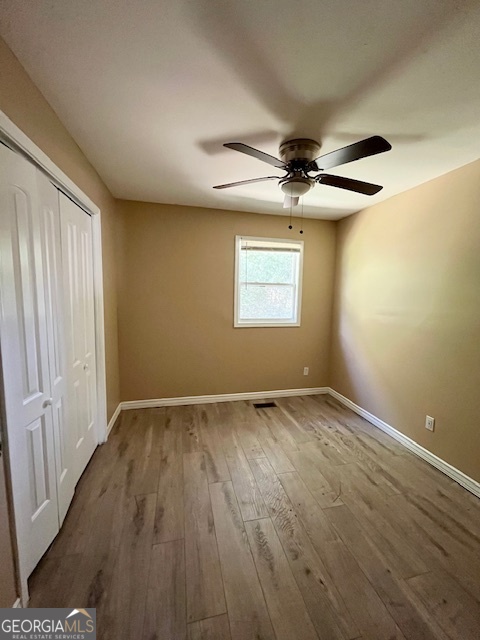 203 Vienna Circle Fort Valley, GA 31030 - Photo 18 of 22 a view of an empty room with a window and wooden floor