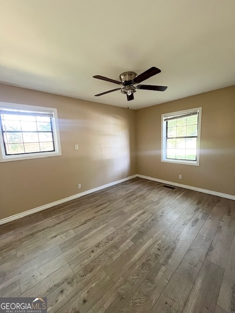 203 Vienna Circle Fort Valley, GA 31030 - Photo 19 of 22 an empty room with wooden floor and windows