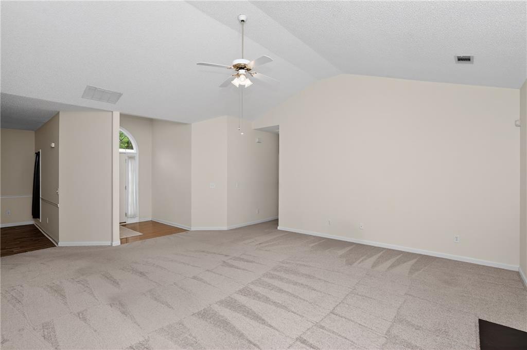 181 Windsor Circle Stockbridge, GA 30281 - Photo 11 of 49 a view of an empty room with a chandelier fan