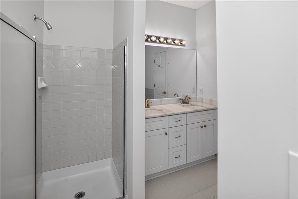 181 Windsor Circle Stockbridge, GA 30281 - Photo 15 of 49 a bathroom with a double vanity sink a mirror and a shower