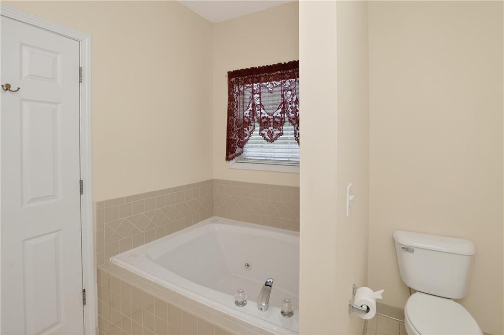 181 Windsor Circle Stockbridge, GA 30281 - Photo 16 of 49 a white bath tub sitting next to a toilet