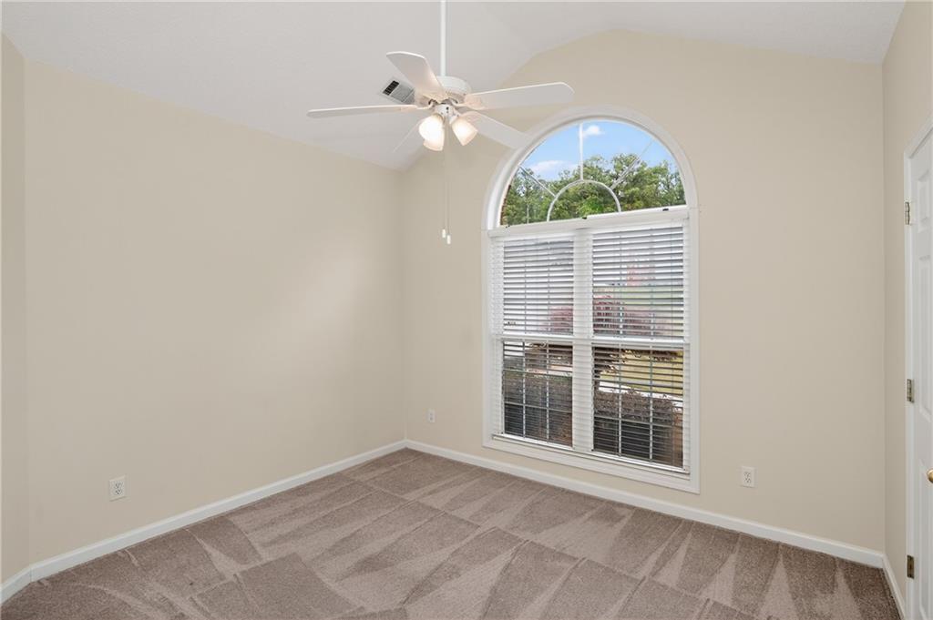181 Windsor Circle Stockbridge, GA 30281 - Photo 27 of 49 an empty room with windows chandelier fan and windows