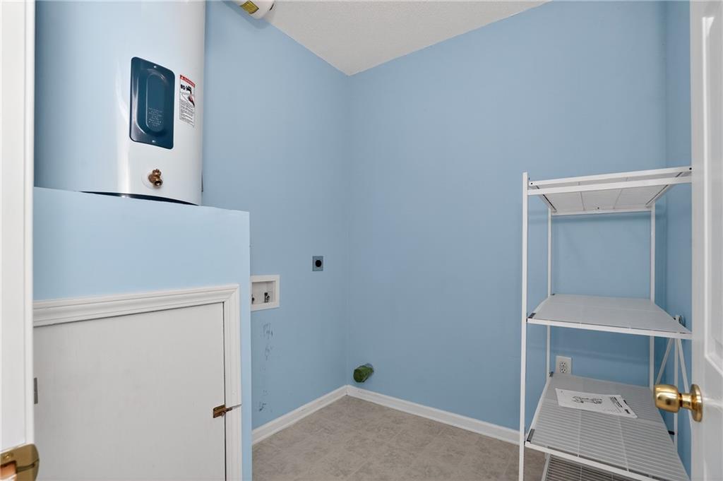 181 Windsor Circle Stockbridge, GA 30281 - Photo 35 of 49 a room with a refrigerator and mirror