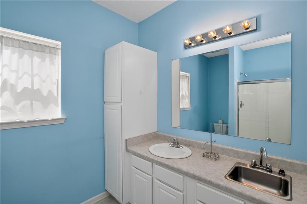 181 Windsor Circle Stockbridge, GA 30281 - Photo 36 of 49 a bathroom with a sink and a mirror