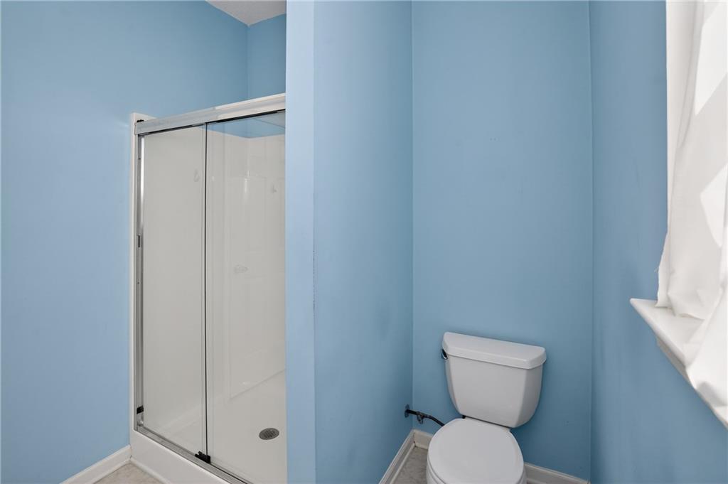 181 Windsor Circle Stockbridge, GA 30281 - Photo 37 of 49 a white toilet sitting next to a shower