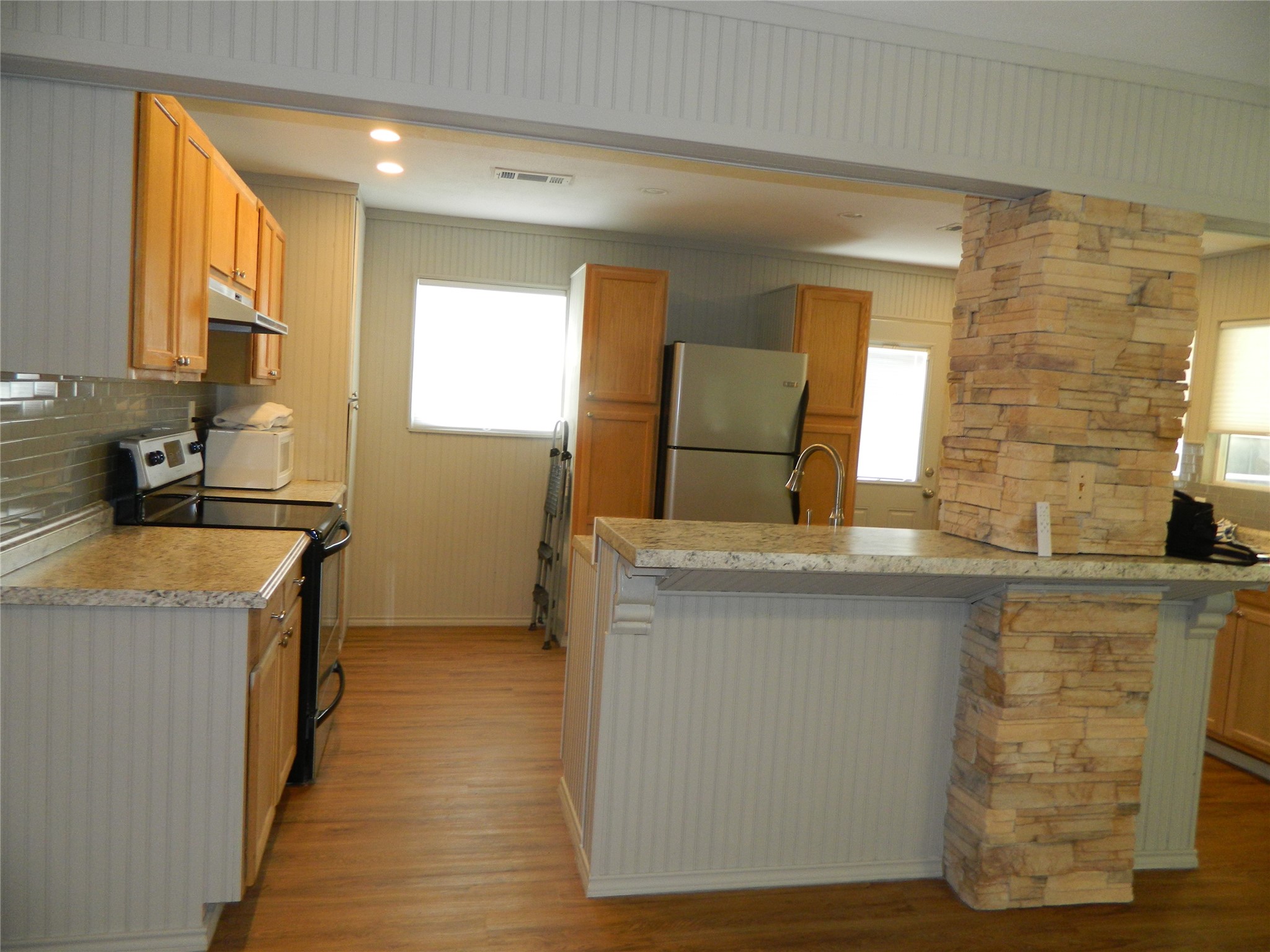 90 Cove Road Coldspring, TX 77331 - Photo 21 of 24 a kitchen with granite countertop a sink and a stove top oven