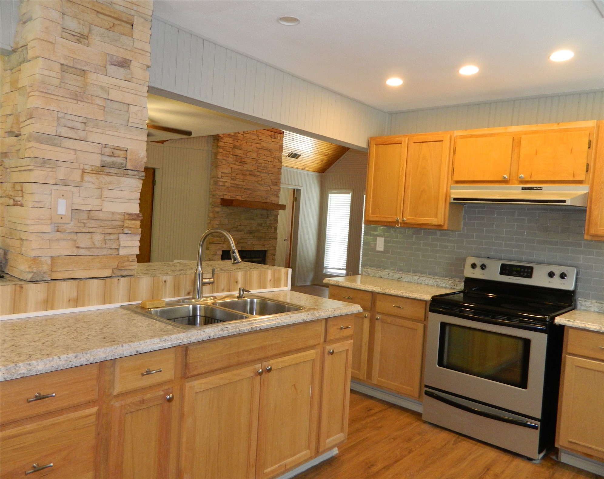 90 Cove Road Coldspring, TX 77331 - Photo 23 of 24 a kitchen with granite countertop a sink stainless steel appliances and cabinets