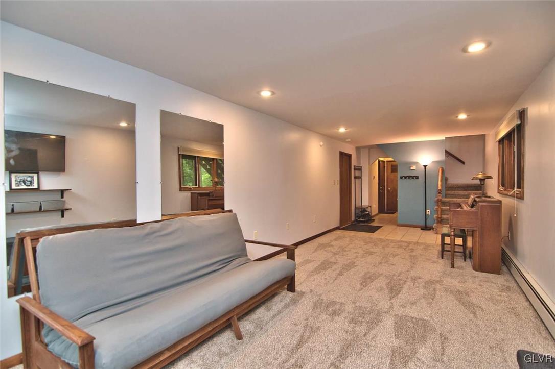 239 Dyson Road Swiftwater, PA 18370 - Photo 36 of 48 a spacious bedroom with a bed a table and chair
