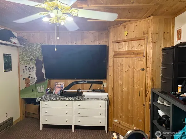 a large bed sitting in a bedroom next to a cabinet