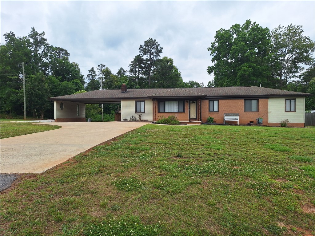 610 Dr Mitchell Road Seneca, SC 29678 - Photo 3 of 47 A well-maintained ranch-style home features a convenient carport and lush front lawn.
