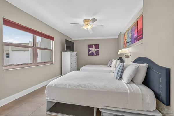 a bedroom with a bed and a painting on the wall