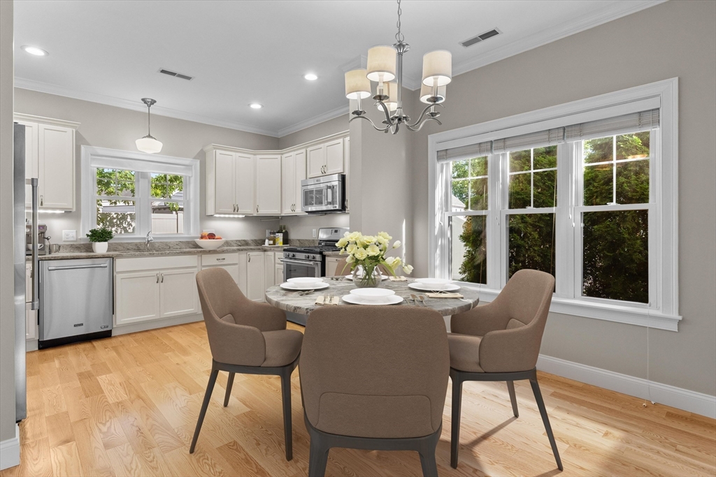 4 Emerald Way, Unit 4 Salisbury, MA 01952 - Photo 13 of 40 a dining room filled chandelier and wooden floor