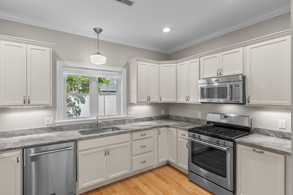 4 Emerald Way, Unit 4 Salisbury, MA 01952 - Photo 17 of 40 a kitchen with granite countertop cabinets stainless steel appliances and a window