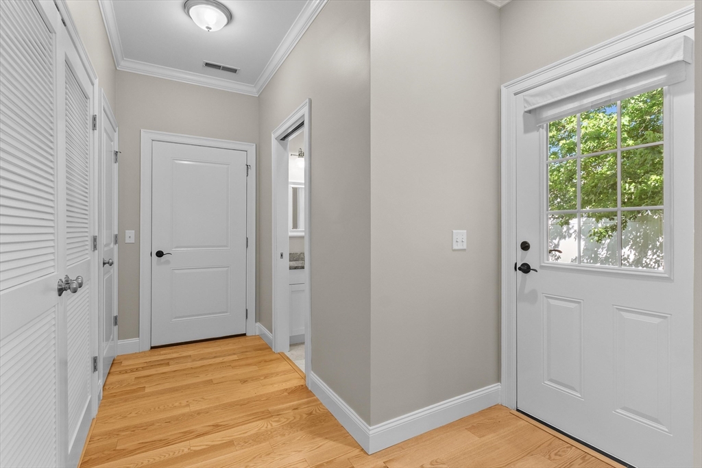 4 Emerald Way, Unit 4 Salisbury, MA 01952 - Photo 19 of 40 a view of a bedroom with wooden floor and windows