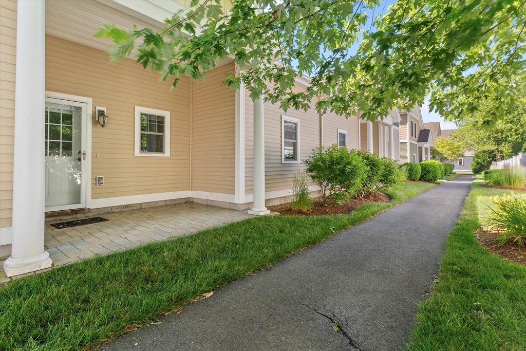 4 Emerald Way, Unit 4 Salisbury, MA 01952 - Photo 22 of 40 a backyard of a house with plants and trees