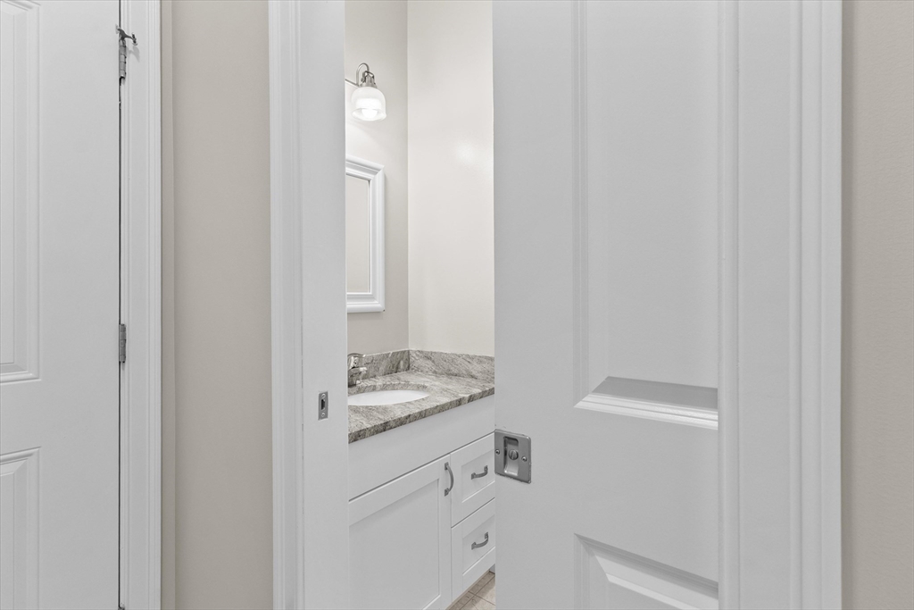 4 Emerald Way, Unit 4 Salisbury, MA 01952 - Photo 23 of 40 a bathroom with a sink and a mirror
